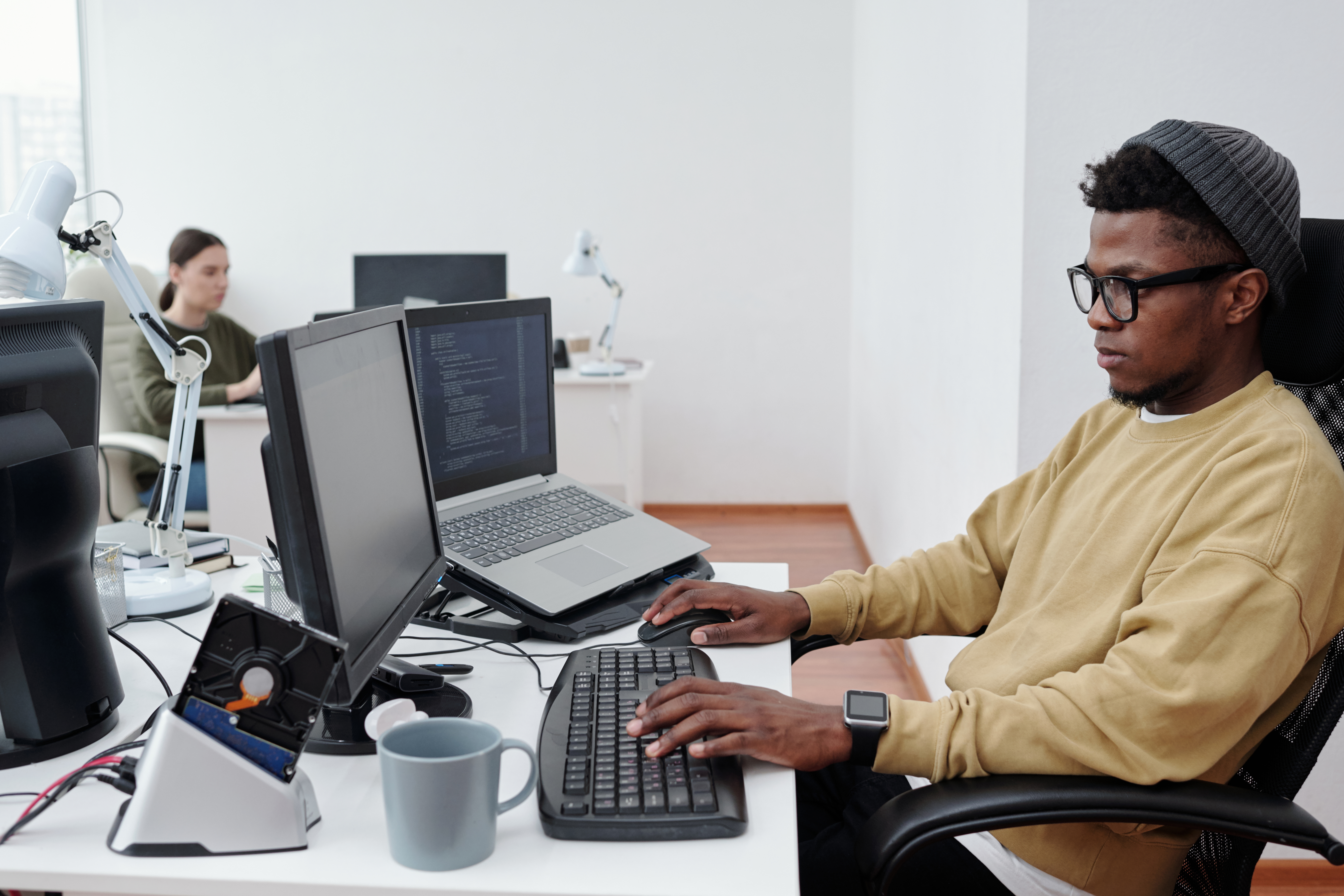 Cover image of the content Career in Platform Engineering featuring a man facing a computer inside an office. On his desk, there is also a notebook, a desk lamp, and other objects.