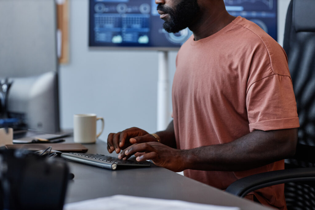 Cover image for the content on Modern Software Engineering: How a Developer Platform Can Take Your IT to the Next Level, featuring a man facing a screen. On his desk, a mug is noticeable.