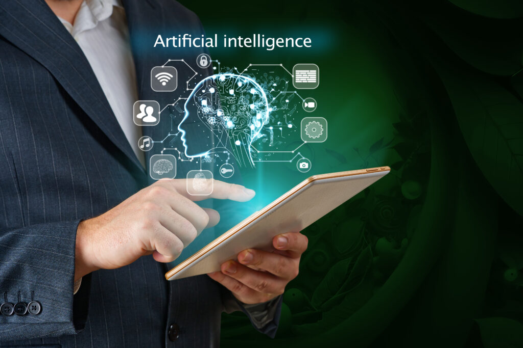 Cover image of the content on Trends in AIOps, featuring a businessman working on a tablet using AI. Business technology, IoT, Internet of Things, and the concept of artificial intelligence.